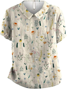 Short-sleeved blouse featuring a vibrant floral pattern, perfect for casual outings or summer events. 0