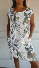 Summer dress featuring a vibrant leaf print and short sleeves, perfect for warm weather outings and casual gatherings. 0