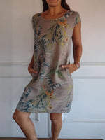 Summer dress featuring a vibrant leaf print and short sleeves, perfect for warm weather outings and casual gatherings. 2