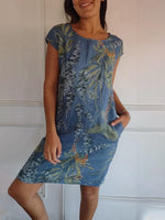 Summer dress featuring a vibrant leaf print and short sleeves, perfect for warm weather outings and casual gatherings. 3
